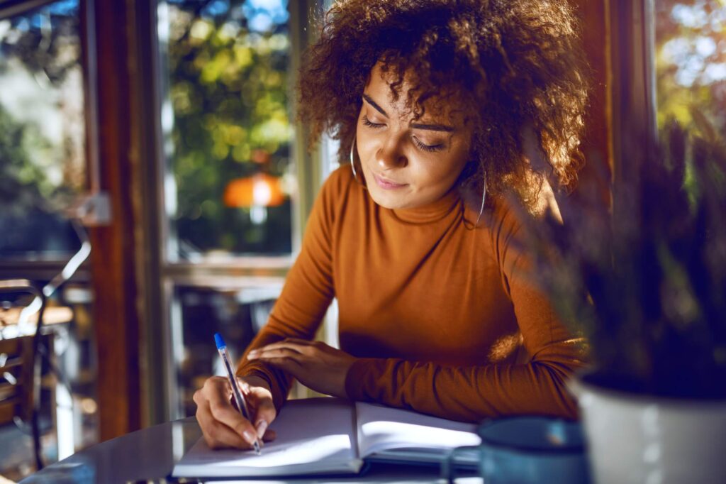Young professional woman writing a business plan