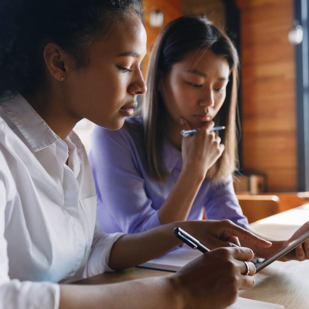 two professional women collaborating on a project.