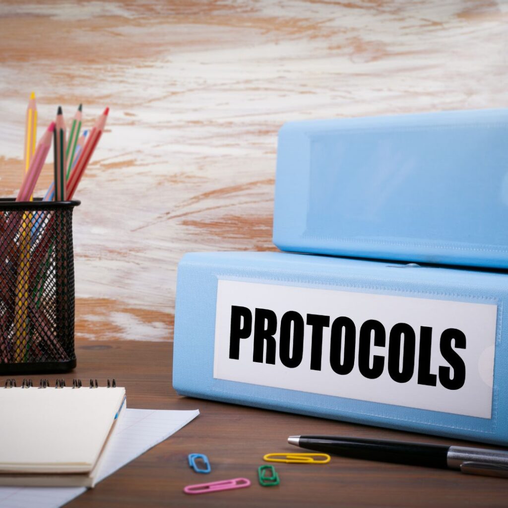 A binder of small business protocols laying on a desk